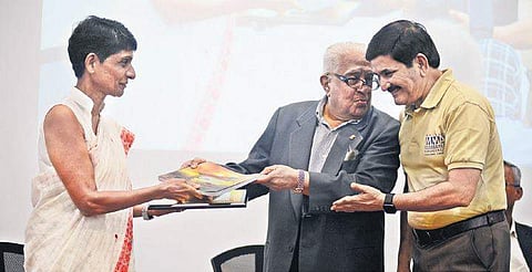 Retd IAS officer P Murari giving a memento to former DGP Letika Saran during the seminar. Retd Gp Captain R Vijayakumar is also seen | DEBADATTA MALLICK
