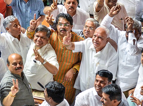 BJP State President BS Yeddyurappa with his party MLAs show victory sign after HD Kumaraswamy lost the vote of confidence during Assembly Session at Vidhana Soudha in Bengaluru Tuesday July 23 2019. | PTI