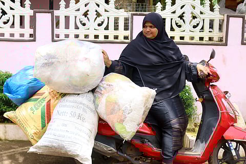 Raina makes the garbage collections on her scooter (Photo | EdexLive)