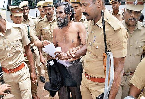 Mugilan removes his shirt to show bruises on his body, alleging torture inside prison, at Karur on Tuesday | Express