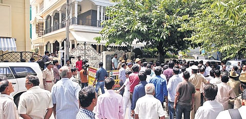 BJP supporters outside the residence of party state chief B S Yeddyurappa in Bengaluru on Wednesday