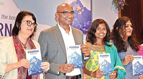 Malavath Poorna (second from right), the youngest girl from Asia to scale Mount Everest, poses with a copy of her newly-released biography, in the presence of US Consul General Katherine Hadda, TSWREIS Secretary RS Praveen Kumar in Hyderabad on Thursday |