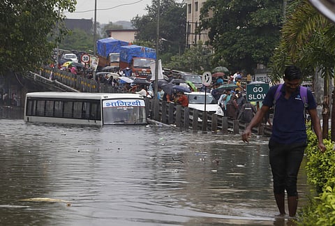 Vehicles ply on a waterlogged street after heavy monsoon rain in Thane Saturday July 27 2019. | PTI