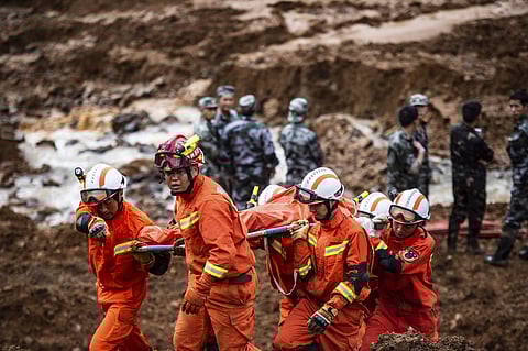 rescue workers recover a body in the aftermath of a landslide at Pingdi Village in Shuicheng County of Liupanshui City, southwestern China's Guizhou Province (File photo | AP)
