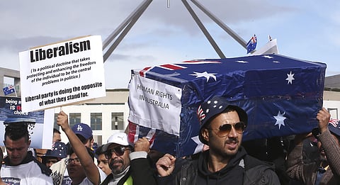 Protestors hold up a placard and a symbolic coffin during a refugee protest at Parliament House in Canberra, Australia, Monday, July 29, 2019. (Photo | AP)