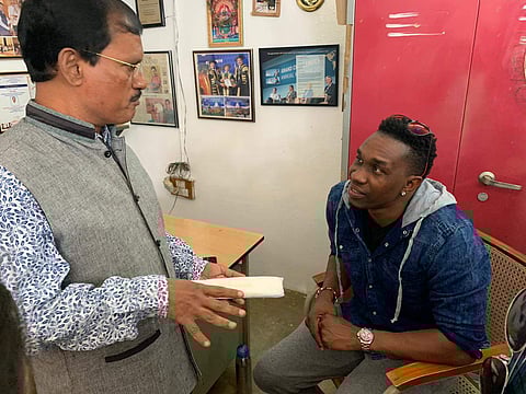 Cricketer Dwayne Bravo interacting with Padman Arunachalam Muruganantham in Coimbatore on Wednesday.Express/Special Arrangement