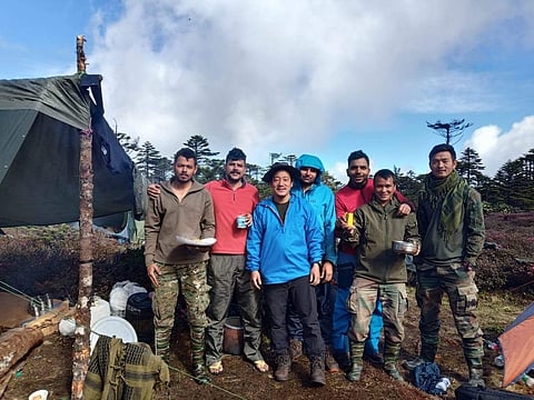 Taka Tamut (in blue) with his team of rescuers who were on a 19-days mission to retrieve the bodies of slain IAF personnel in Arunachal. (Photo | EPS)h