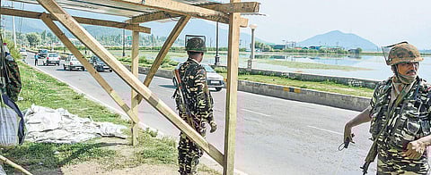 Security personnel stand outside a newly constructed bunker on the banks of Dal Lake in Srinagar. New security bunkers have been constructed in many parts of Srinagar as tensions mounted in Kashmir over the deployment of 100 companies of additional securi