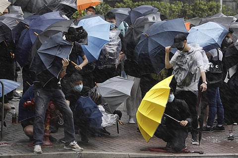 Protesters brace themselves against the strong wind and heavy rain as they gather outside the Eastern Court in Hong Kong, Wednesday, July 31, 2019. (Photo | AP)