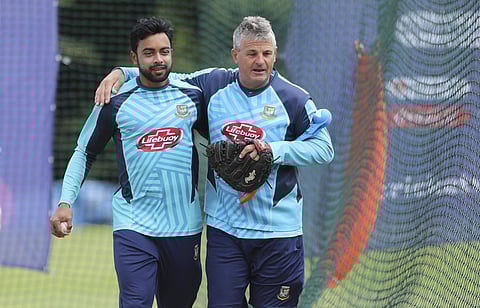 Bangladesh's Abu Jayed, left, and team coach Steve Rhodes share a light moment in the nets during a training session ahead of their Cricket World Cup match against India at Edgbaston in Birmingham. (Photo | AP)