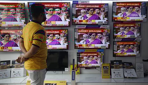 A man watch Finance Minister Nirmala Sitharaman tabling the Union Budget 2019-20 on TV sets at a showroom in Delhi. (Photo | Arun Thakur, EPS)
