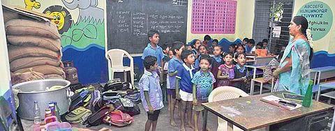 A teacher takes a class on happiness in a classroom that looks like filled with bags and utensils at a school in Vijayawada. (Photo | Prasant Madugula)