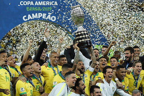 Brazil's Dani Alves lifts up the trophy after winning the Copa America final against Peru at the Maracana stadium (Photo | AP)