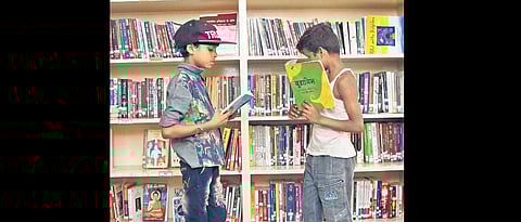Children reading books at a library. ( Photo | EPS)