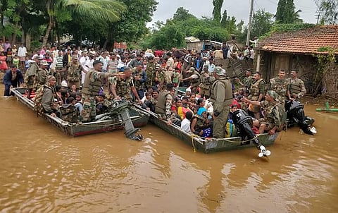 Army personnel move residents to safety in the flood-hit Gokak taluk in Belagavi district on Friday. (Photo | EPS)