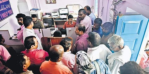 People wait for their turn to record thumb impression and digital photograph at the Sub Registrar Office at Ibrahimpatnam, Rangareddy district (Photo| EPS, Vinay Madapu)