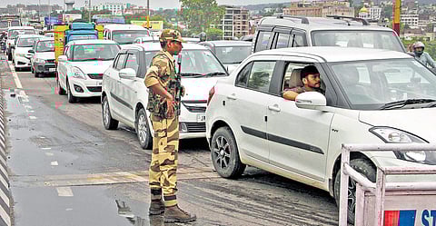 A security personnel stands guard as vehicles plied normally after five days of security clampdown in Jammu on Saturday | PTI
