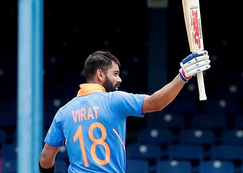 India's captain Virat Kohli rises his bat as he celebrates his century against West Indies. (Photo | AP)