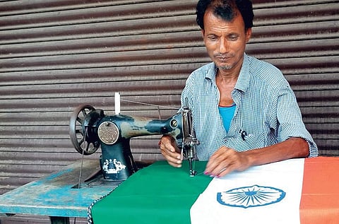 A tailor stitching a national flag in Kendrapara | Express
