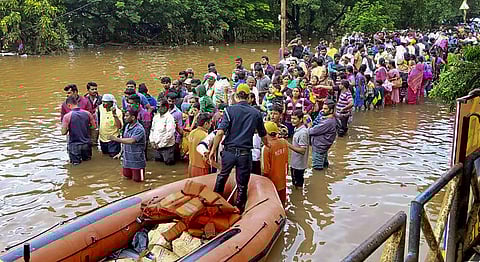 NDRF personnel provide relief material in a flood-affected area following heavy rain in Sangli Sunday August 11 2019. | PTI
