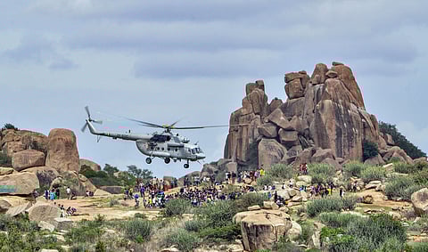 An Indian Air Force helicopter descends on Hampi island to rescue stranded tourists due to flood in Koppal district Monday August 12 2019. | PTI