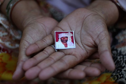 Jaibuni, wife of Pehlu Khan, holding a picture of her late husband in their home in Jaisingh Pur Village in Nuh Haryana. (Photo | Arun Kumar, EPS)