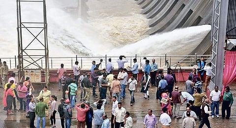 People watch water being released from the Hirakud dam on Wednesday | Express