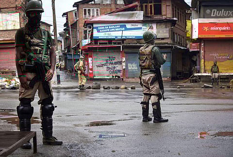 Security personnel guard in a street during curfew like restrictions following abrogation of the provisions of Article 370 in Srinagar Wednesday Aug. 14 2019. | PTI