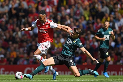 Arsenal's Gabonese striker Pierre-Emerick Aubameyang (L) vies with Burnley's English defender James Tarkowski during the English Premier League football match between Arsenal and Burnley at the Emirates Stadium in London. (Photo | AFP)