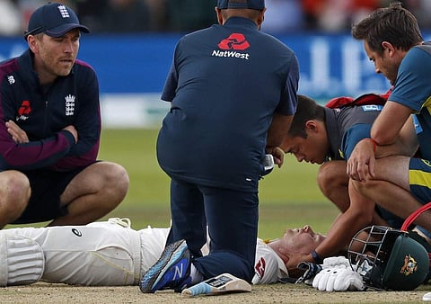 Australia's Steve Smith lays on the pitch after being hit in the head by a ball off the bowling of England's Jofra Archer (unseen) during play on the fourth day of the second Ashes cricket Test match. (Photo | AFP)