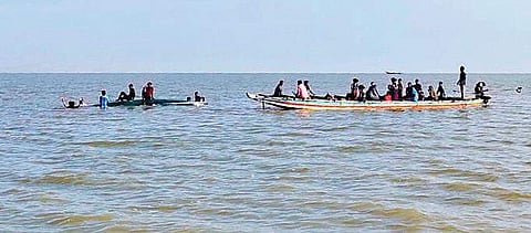 The passengers rescued from a capsized boat are being shifted to another boat in Mahanadi river