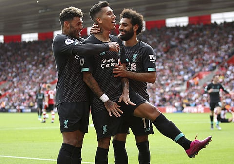 Liverpool's Roberto Firmino, centre, celebrates scoring his side's second goal of the game. (Photo | AP)