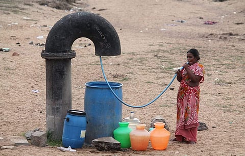 A woman, waiting with empty water pots. Image used for representational purposes.