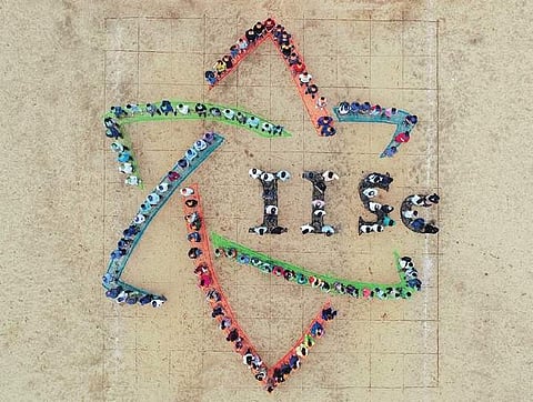 (Above) Students and faculty members of Indian Institute of Science make a formation of their new logo, in Bengaluru, on Tuesday; (Left) A student protests against the logo by sporting a printout of a detergent company logo on his T-shirt