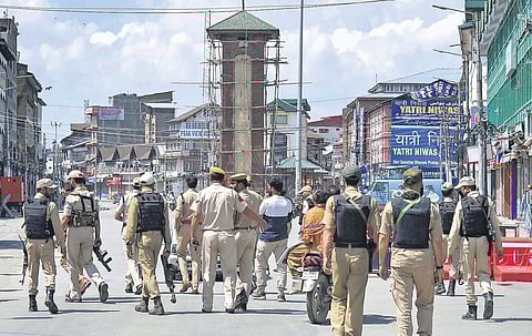 Policemen patrolling at Lal Chowk after restrictions were lifted in Srinagar on Tuesday. Barricades around the Clock Tower in the city centre were removed | PTI
