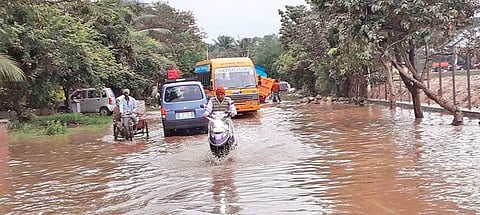 Vehicles struggle to commute through the water-logged Horamavu Agara Road on Tuesday