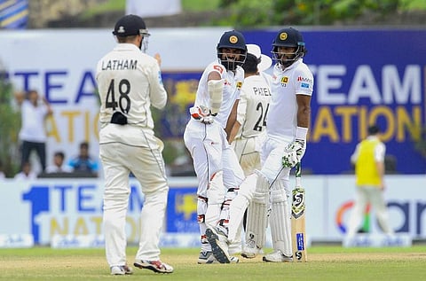 Sri Lanka's cricket captain Dimuth Karunaratne (R) and Lahiru Thirimanne (C) look on. (Photo | AFP)