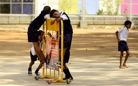 Kids play on the metal barricade at National College ground in Bengaluru (File Photo | Shriram BN, EPS)