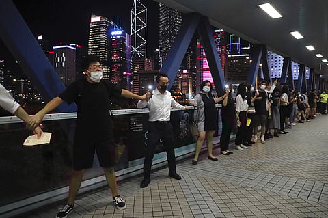 Demonstrators link hands as they gather along an elevated walkway in Hong Kong, Friday, Aug. 23, 2019. (Photo | AP)