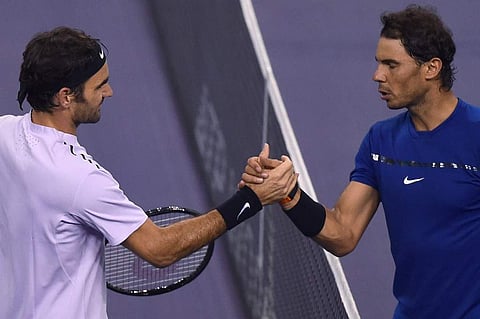 Roger Federer of Switzerland (L) shakes hands with Rafael Nadal of Spain. (Photo | AFP)
