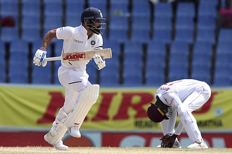 India's captain Virat Kohli scores runs against West Indies during day three of the first Test cricket match at the Sir Vivian Richards cricket ground in North Sound. (Photo | AP)