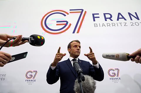 France's President Emmanuel Macron gestures as he speaks to the press after a plenary session at the Bellevue centre in Biarritz, France. (Photo | AP)