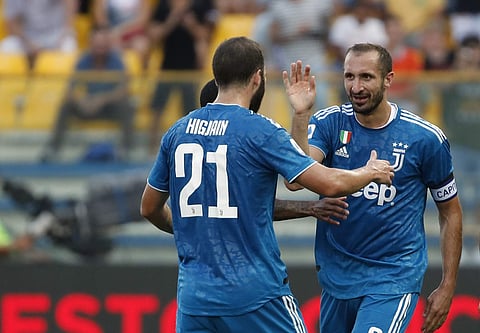 Juventus' Giorgio Chiellini, right, celebrates with teammates after scoring his side's opening goal during the Serie A soccer match between Parma and Juventus at the Tardini stadium, in Parma, Italy, Saturday, Aug. 24, 2019. | AP