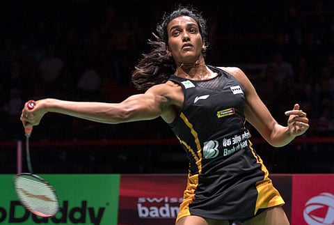 PV Sindhu returns a shuttlecock to Japan's Nozomi Okuhara during their women's singles final match at the BWF Badminton World Championships in Basel. (Photo | AP)