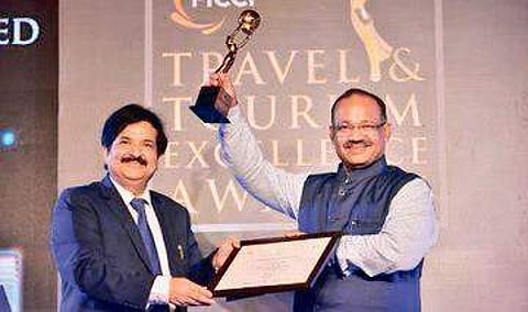 Tourism Minister Jyoti Prakash Panigrahi receiving award at a function in New Delhi