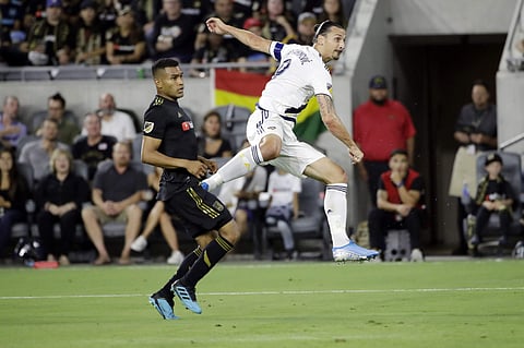 Los Angeles Galaxy's Zlatan Ibrahimovic, right, shoots next to Los Angeles FC's Eddie Segura during the first half of an MLS soccer match. (Photo | AP)