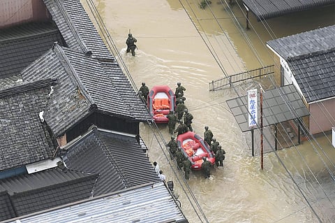 Japan's Self-Defense Forces members are on the way through a flooded street for a rescue operation in Takeo, Saga prefecture, southern Japan following a heavy rain Wednesday, Aug. 28, 2019. | ( Photo | AP )