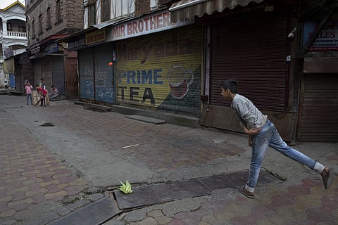 Kashmiri children play cricket outside a closed market in central Srinagar, Tuesday, August 27, 2019. | AP