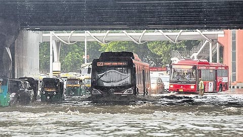 Vehicles wade through waterlogged road under the rail bridge at ITO | ( File Photo )