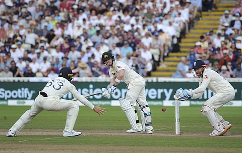 Australia's Steven Smith, centre, plays a shot watched by England's Jonny Bairstow, right, and England's Jos Buttler during day three of the first Ashes Test cricket match between England and Australia at Edgbaston in Birmingham. (Photo | AP)